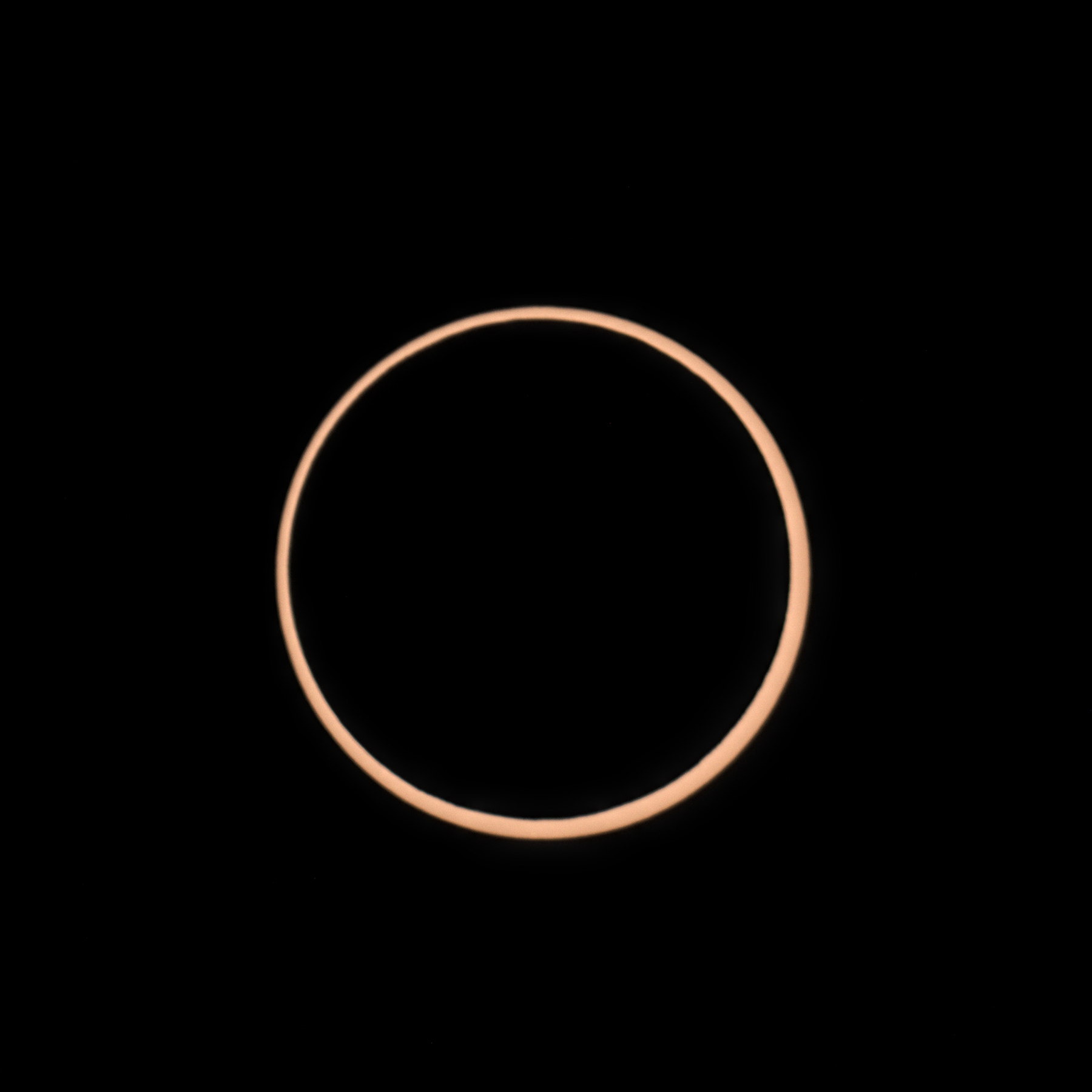 The sun is eclipsed entirely by the moon, except for a perfect thin ring around the outside.