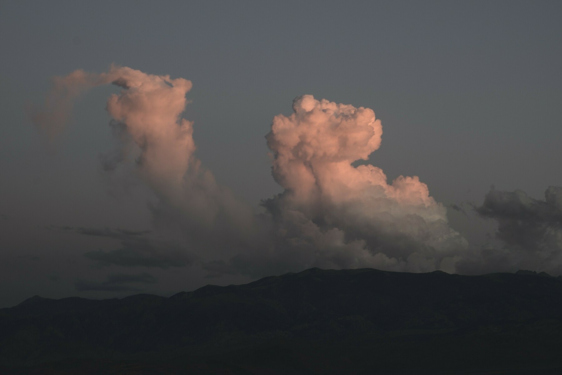 Pink cumulonimbus clouds look vaguely animated.
