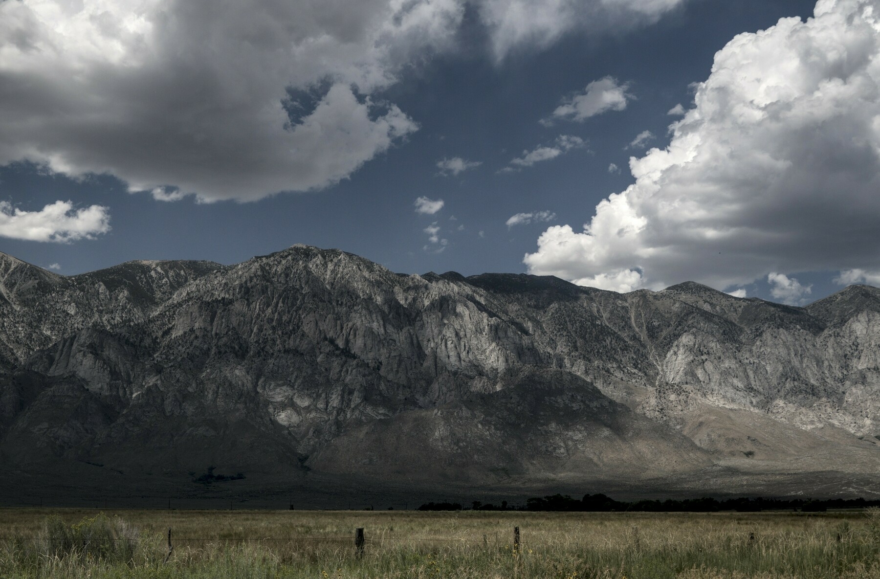 Partial clouds over a large granite escarpment.