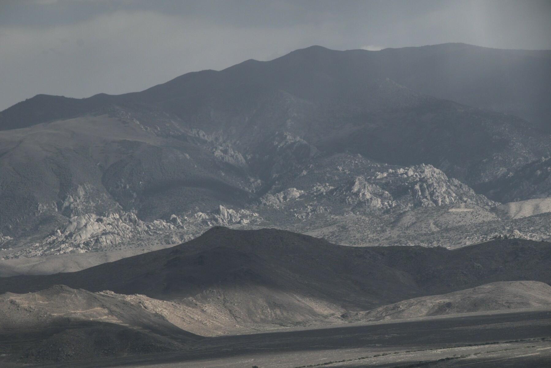 Alternating shadow and light bring out the structure of foothills.