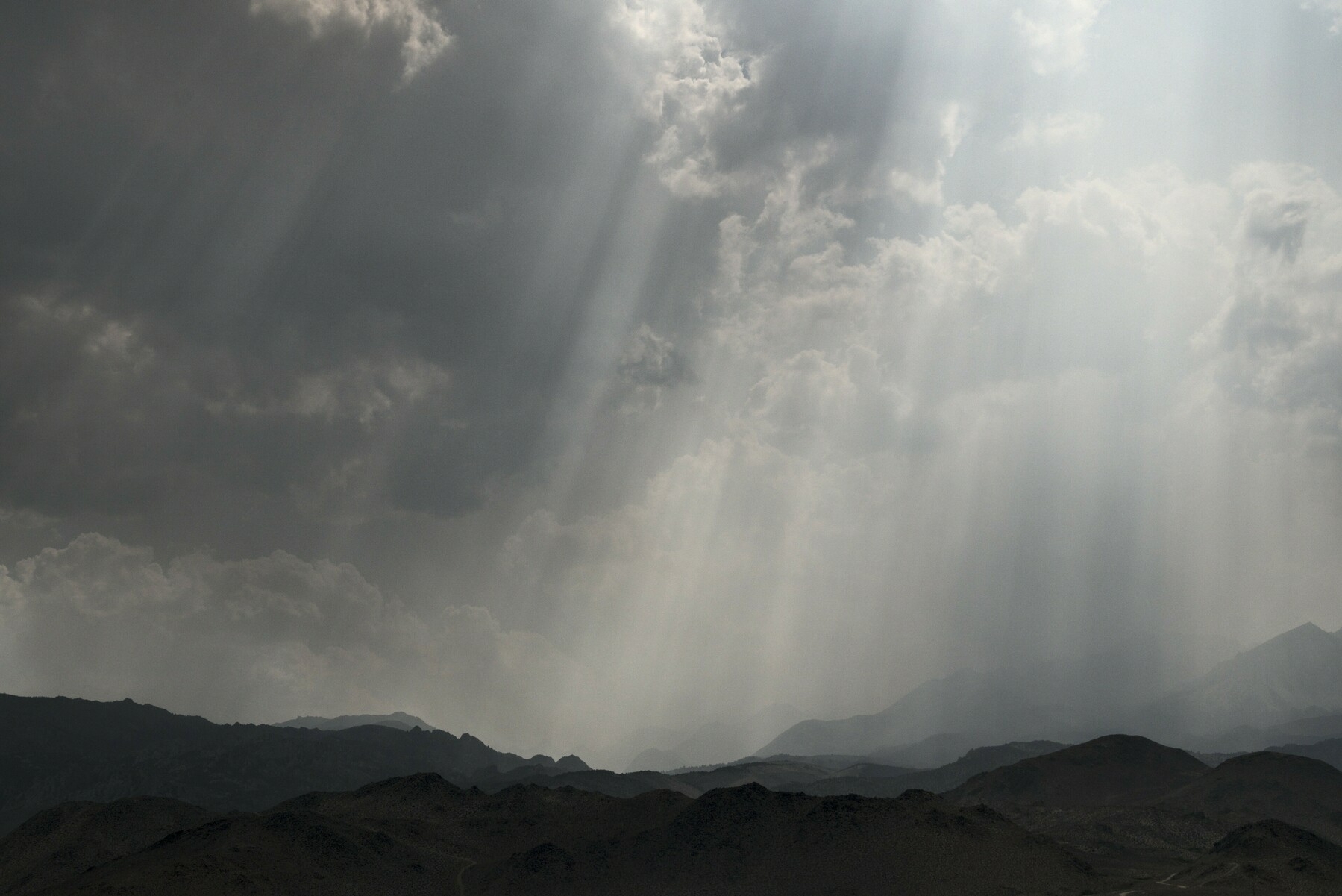 Sun rays streak through smoky clouds.