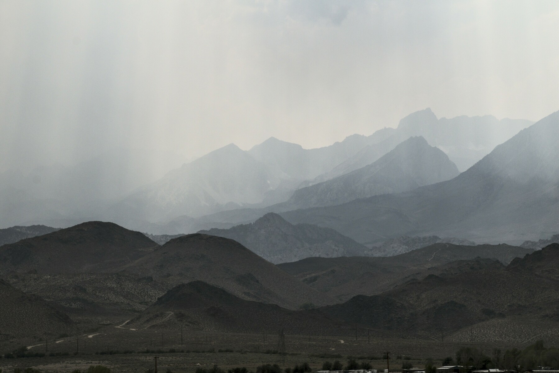 A view of foothills to high mountains, getting hazier from smoke as you go up.