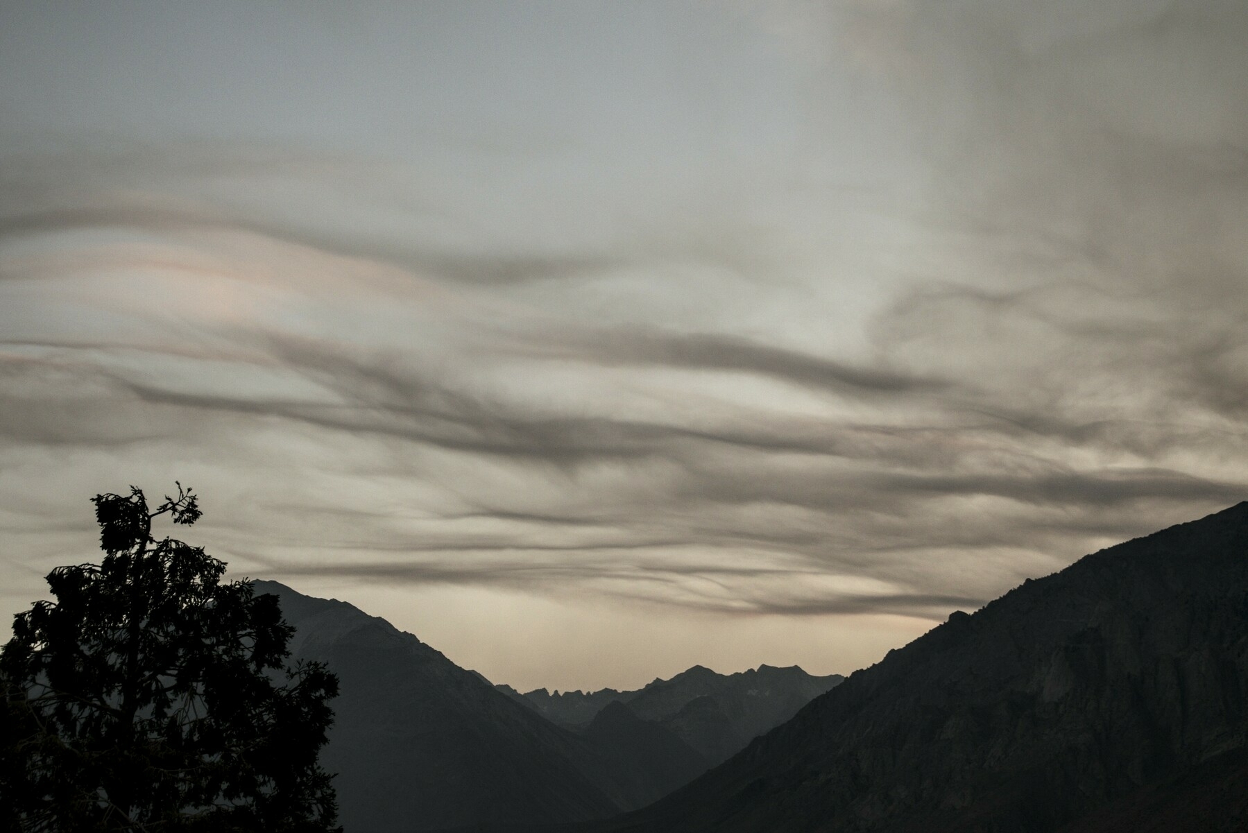 Wavy clouds have an odd color from smoke.