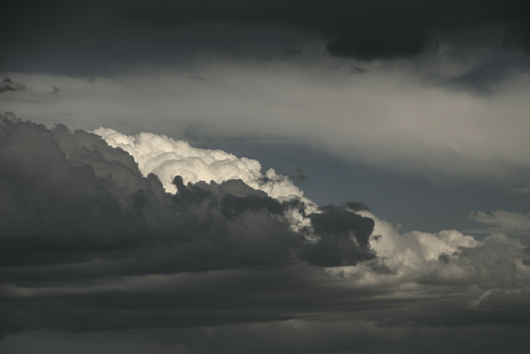 Varying grey clouds look like figures low to the ground.