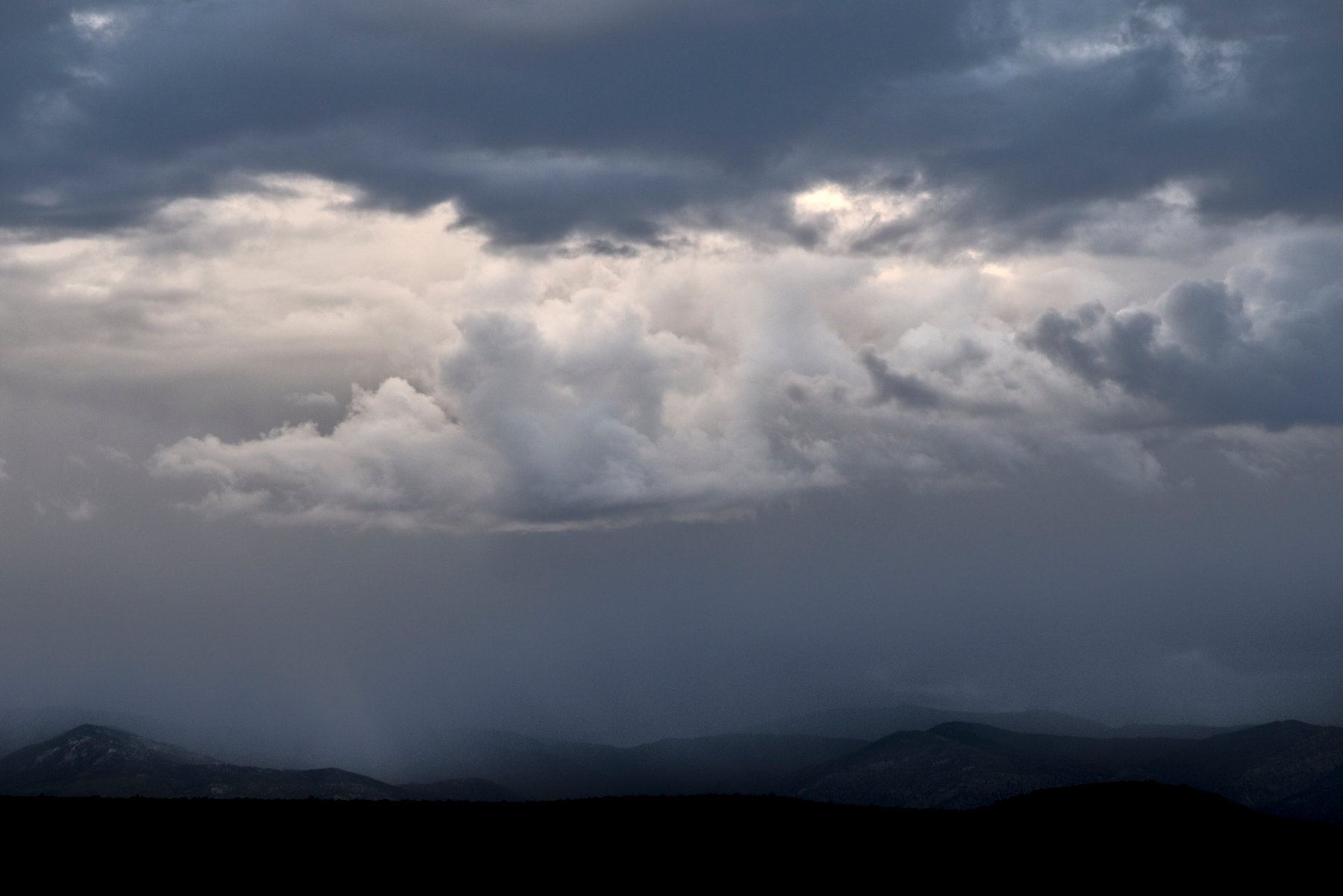 Stormy sky with contrasting grey clouds.