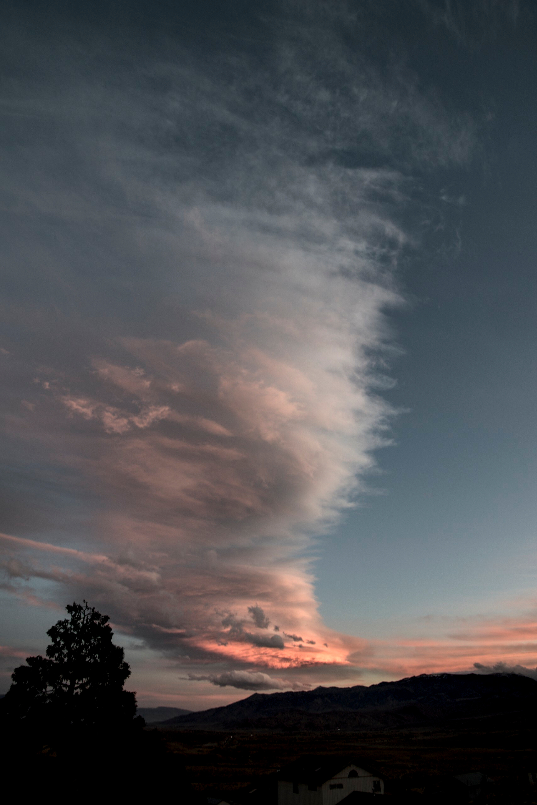 Clouds rise in a tall column that looks like a beehive hairdo.