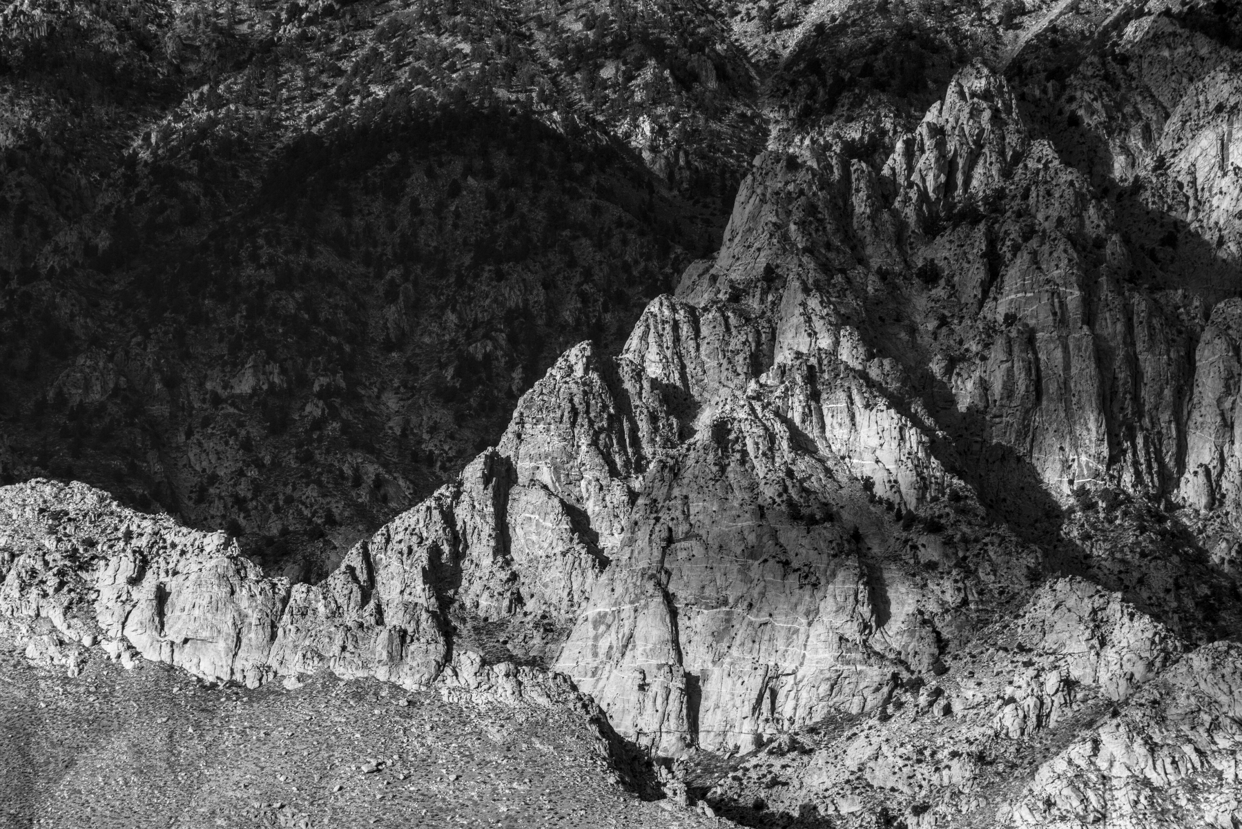 A ridge of rough granite that is part of a much larger cliff face.