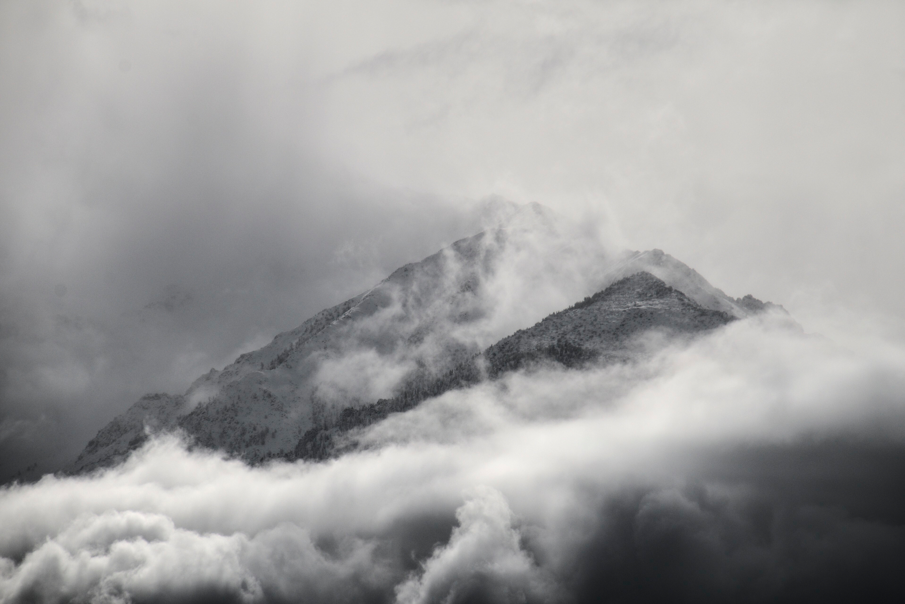 A large triangular mountain covered in fog.