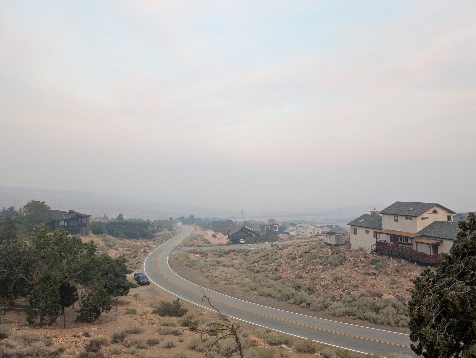 A view of houses is obscured by smoke.